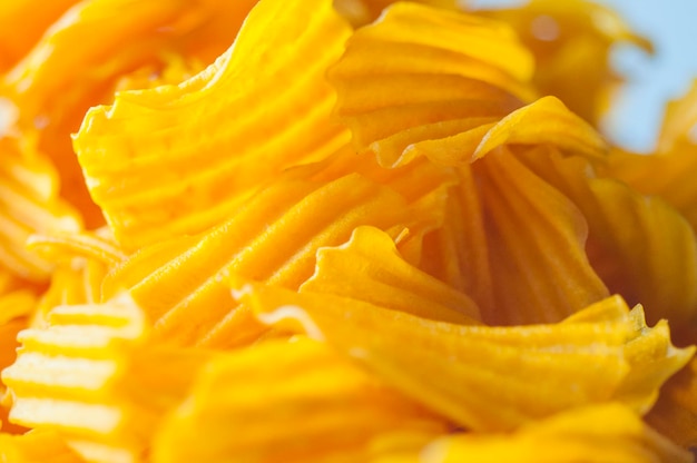 Closeup golden yellow sweet potato chips white background