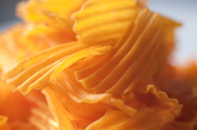 Closeup golden yellow sweet potato chips white background