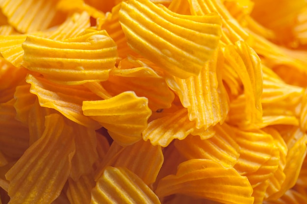 Closeup golden yellow sweet potato chips white background