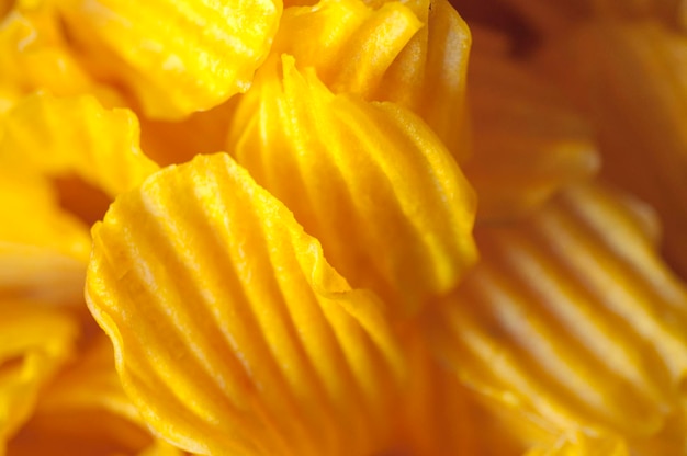 Closeup golden yellow sweet potato chips white background