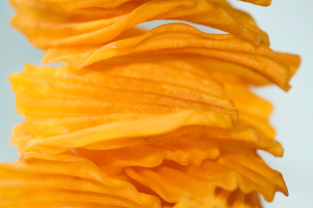 Closeup golden yellow sweet potato chips white background