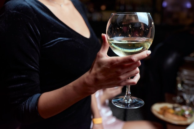 Closeup of gorgeous woman with a glass of champagne party and holiday celebration