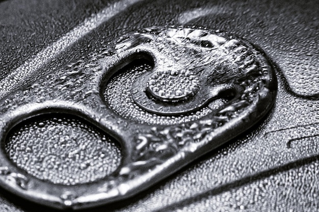 Closeup grayscale shot of a wet iced metal Can lid