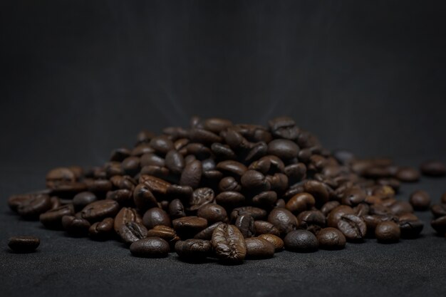 Closeup group of coffee beans  on the dark background