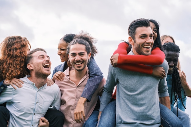 Closeup of group of friends from different cultures having fun together outdoors