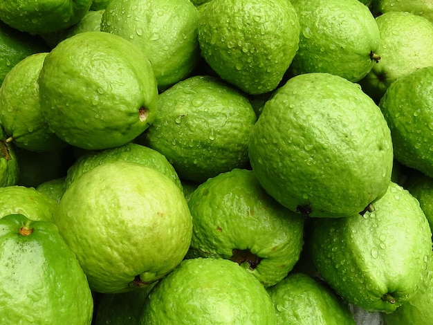 Closeup of guavas with waterdrops on them under the lights - perfect for food concepts