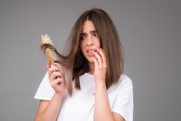 Closeup hair loss hair fall in hairbrush stress problem of woman with a comb