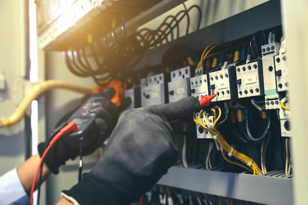 Closeup hand of electrical engineering using measuring to checking electricity