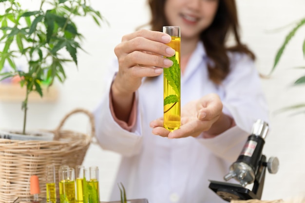 Closeup hand holding cannabis in test tube in the lap