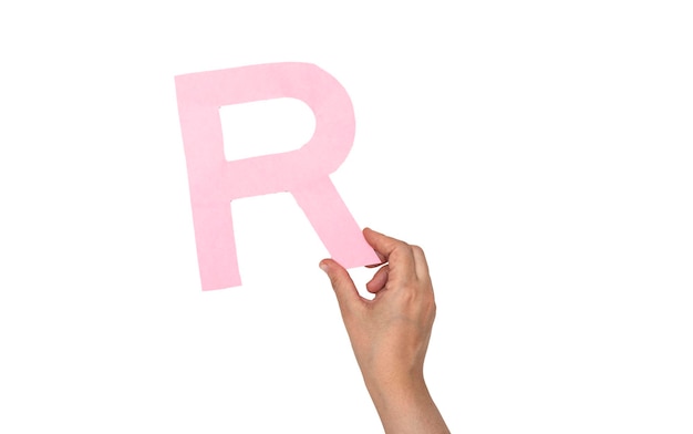 closeup hand holding paper letter R isolated on white