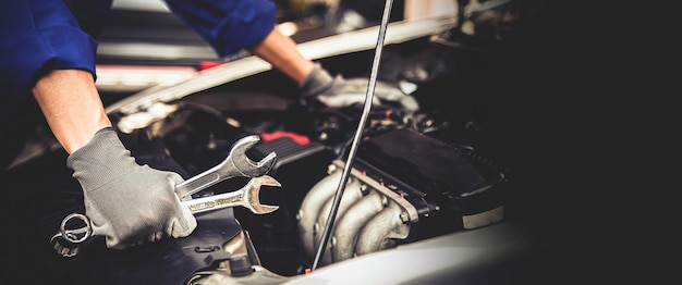 Closeup hand technician holding the wrench to repairing car