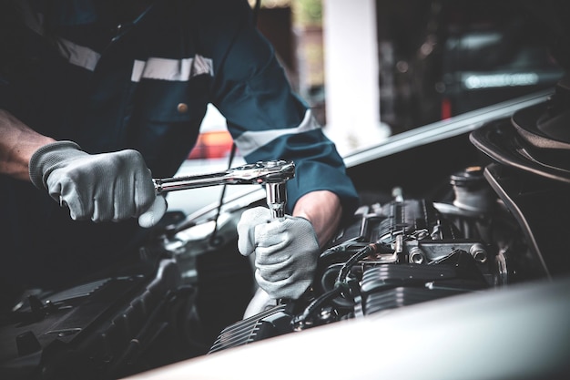 Closeup hand technician using the wrench to repairing car