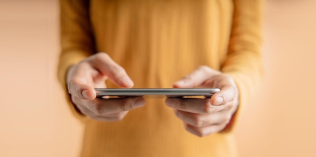 Closeup of Hand Using Mobile Phone Cropped image Selective Focus Using Smartphone for Communication Texting Reading or Playing Game