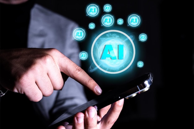 Closeup of a hand with a mobile phone and the Artificial Intelligence symbol Concept of the use of Artificial Intelligence with the mobile phone