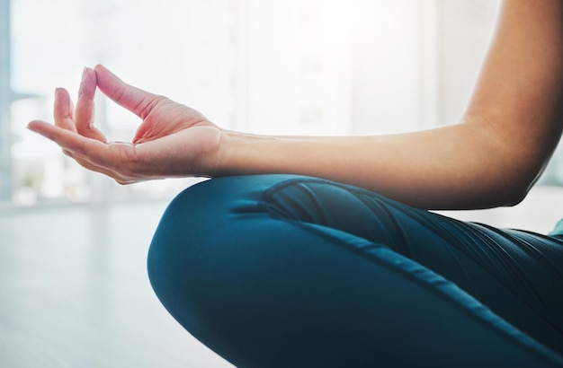 Closeup hand and woman with meditation yoga and peace for balance wellness and healthy lifestyle Zoom female yogi and lady in position pilates training and posture to relax fitness and calm