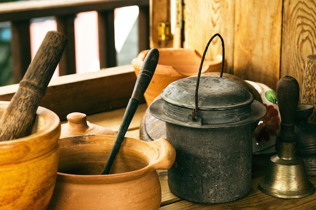 Closeup of handicraft made kitchenware on wooden table in rural house