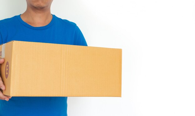 Closeup hands of delivery man holding package to deliver