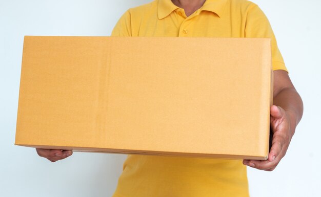 Closeup hands of delivery man holding package to deliver