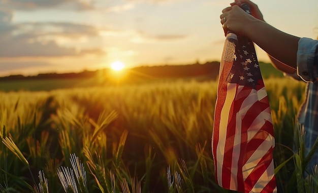 CloseUp of Hands Holding American Flag Over Wheat Field at Sunset