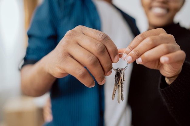 Closeup of hands holding keys to an apartment married couple buying renting a new apartment the begi