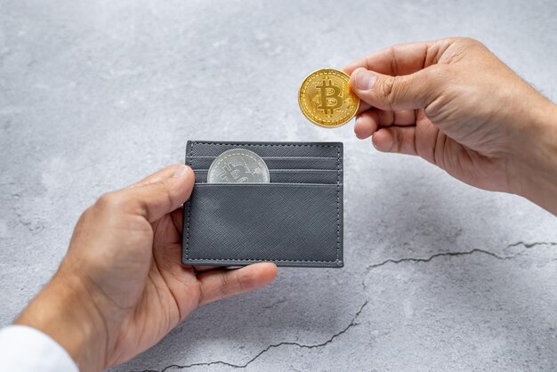 Closeup of hands holding a wallet with bitcoin coins The concept of electronic decentralized money