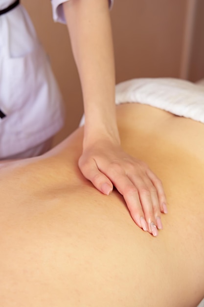 Closeup of the hands of a masseur doing back massage therapeutic massage back treatment scoliosi