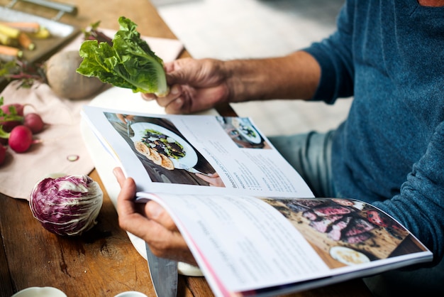 Photo closeup of hands open reading cooking book