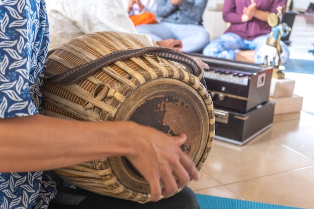 Closeup of hands playing a drum for meditation to chant mantras