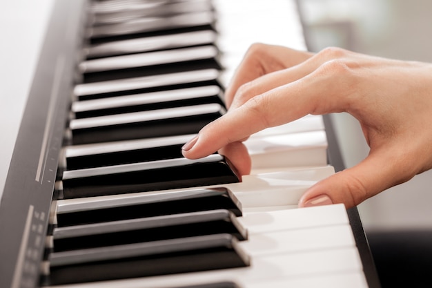 Closeup of hands playing piano. Music and hobby concept