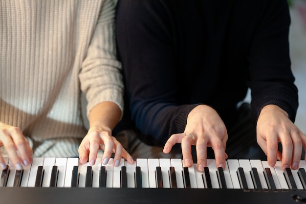 Closeup of hands playing piano. Music and hobby concept