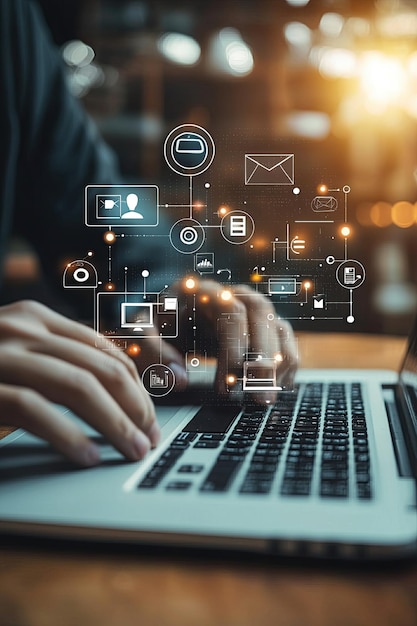 Closeup of hands typing on a laptop with digital icons overlay