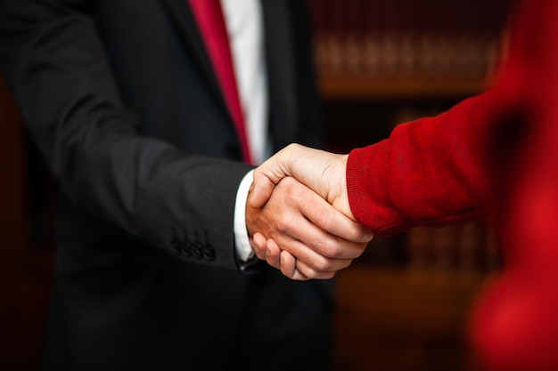 Closeup of a handshake between a lawyer and his customer