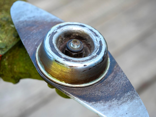 Closeup of the head of a gasoline lawn mower with a blade for cutting tall grass Garden equipment