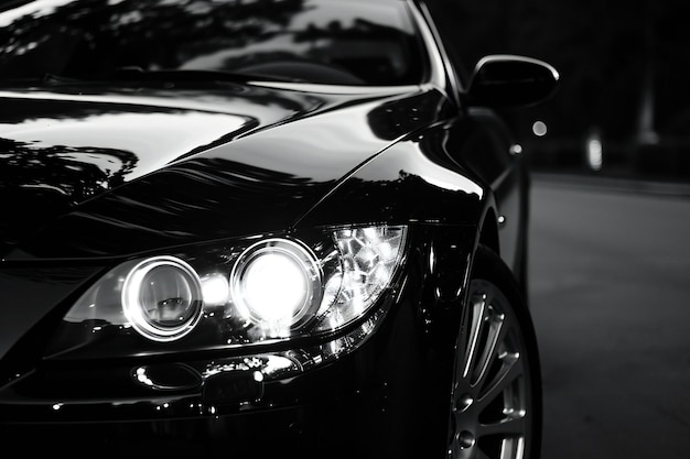 Closeup of the headlight of a black sports car