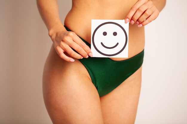 Closeup Of Healthy Female With Beautiful Fit Slim Body Holding Card With Happy Smiley