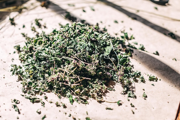 Closeup heap of dry herbs on table background