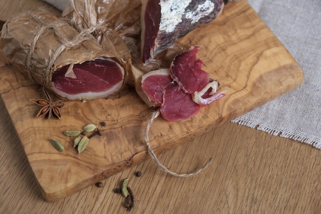 Closeup homemade duck jamon homemade snack jerky on board selective focus