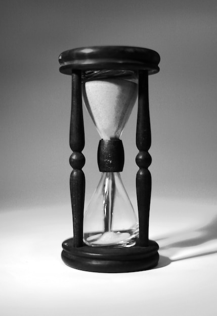 Closeup of hourglass. isolated on blue background.photo with copy space