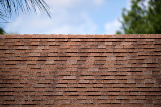 Closeup of house roof top covered with asphalt or bitumen shingles Waterproofing of new building