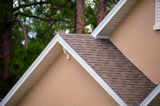 Closeup of house roof top covered with asphalt or bitumen shingles Waterproofing of new building