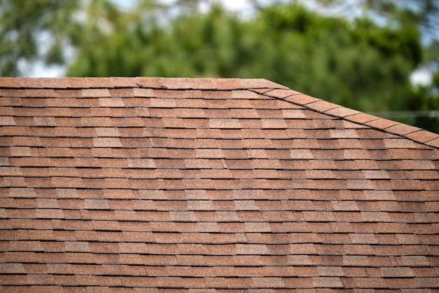 Closeup of house roof top covered with asphalt or bitumen shingles Waterproofing of new building