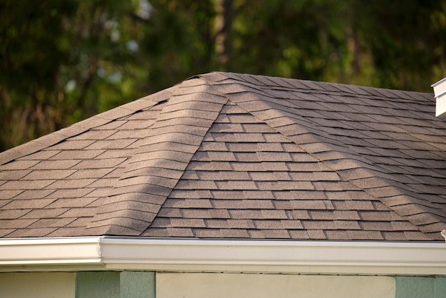 Closeup of house roof top covered with asphalt or bitumen shingles Waterproofing of new building