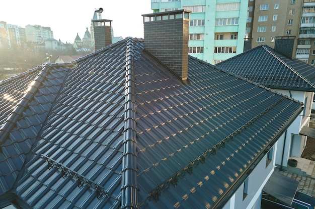 Closeup of house roof top covered with ceramic shingles Tiled covering of building