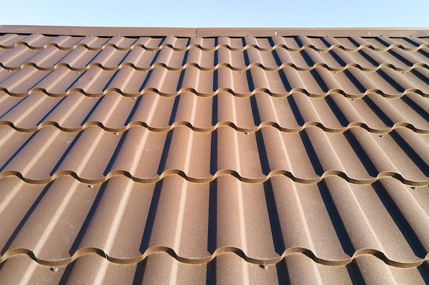 Closeup of house roof top covered with metallic shingles.