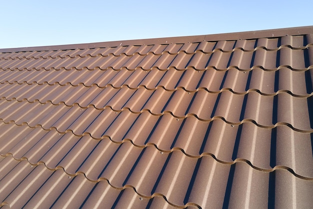 Closeup of house roof top covered with metallic shingles.