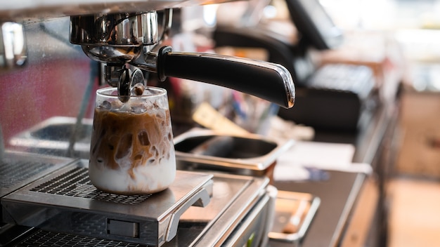 Closeup of iced coffee served on black table at cafe