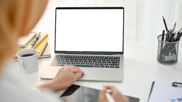 Closeup image of an Asian Muslim businesswoman working in her office using laptop