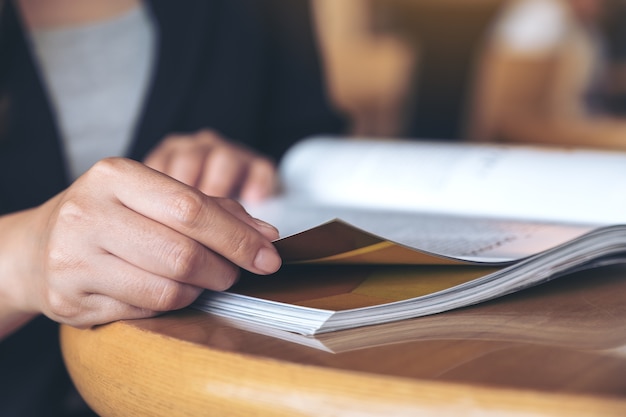 Closeup image of a business woman reading a book in modern cafe 