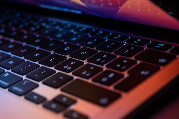 Closeup image of modern ultrabook laptop with backlight keyboard and colorful display background