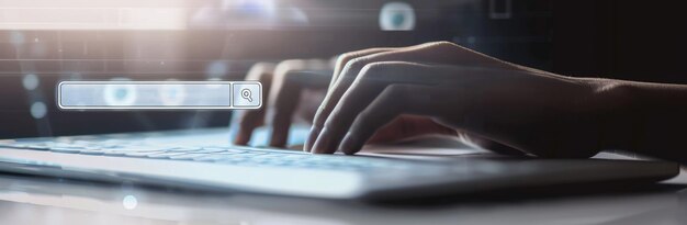 Photo a closeup image showing a hand typing on a laptop keyboard with a search bar overlay aig